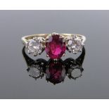 An 18ct gold 3 stone ruby and diamond ring, total diamond content approx. 0.