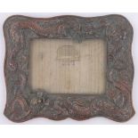 A Chinese antimony frame circa 1900, with relief cast dragon design surround, overall 34cm x 27cm.