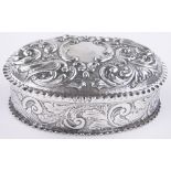 A Victorian oval silver box, relief embossed birds and flowers by William Comyns, London 1889, 6.