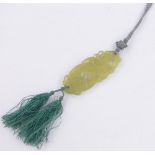 A Chinese relief carved and pierced jade pendant on silk cord, pendant length 70mm.