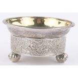 A 19th century Russian circular silver salt, with relief floral frieze, makers marks E C,