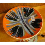 A Poole Pottery plate with painted abstract design.