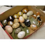 A collection of turned hardstone eggs, a dog on onyx stand, etc.