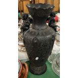 A black Basalt Ware vase with cherub handles.