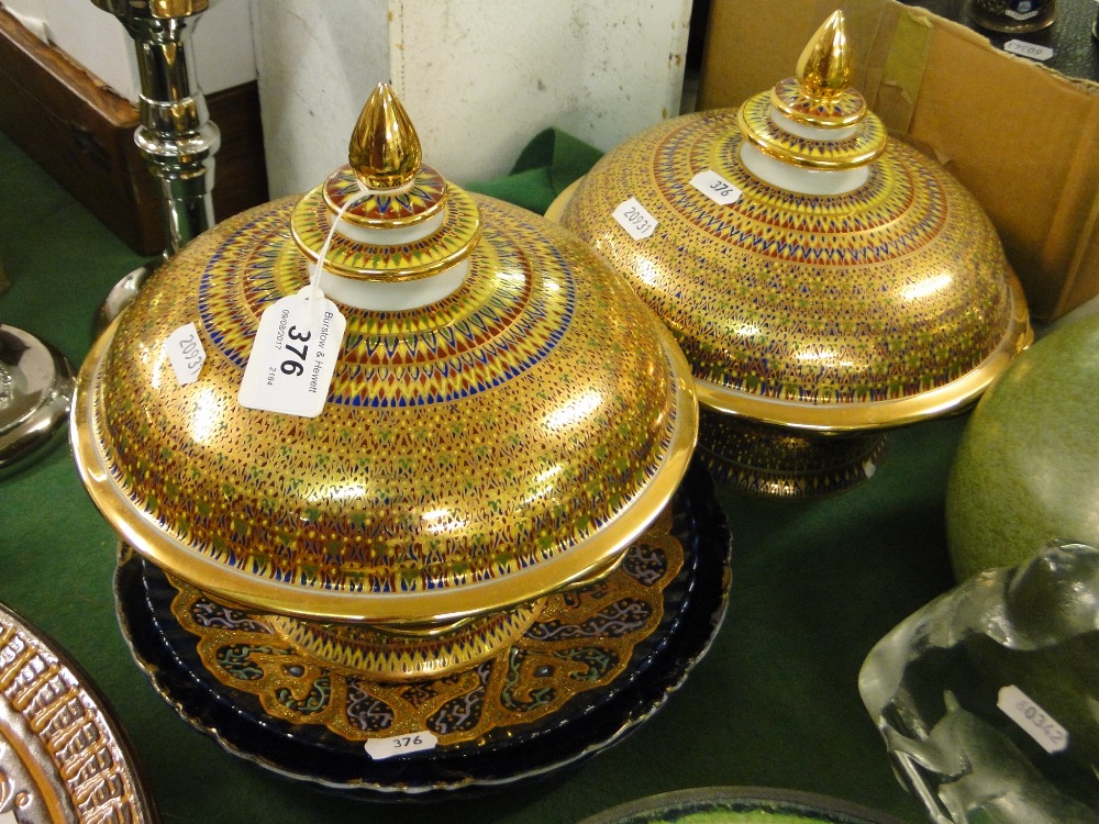 A pair of continental gilded comports, pair of portrait plates and another.