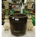 A coopered oak barrel with brass bands and a pair of painted wood pricket candlesticks.