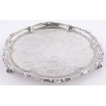 A Victorian circular silver card salver, cast shaped border on ball and claw feet, by Martin Hall,