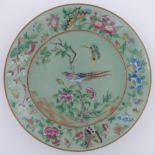 A Chinese celadon porcelain dish, painted enamel exotic bird, butterfly and flowers, diameter 26cm.