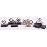 A set of 9 Maltese silver menu card holders, Maltese hallmarks on ebonised plinths,