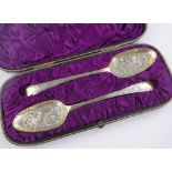 Cased pair of George III chased silver gilt berry spoons, indistinct makers marks, London 1780.