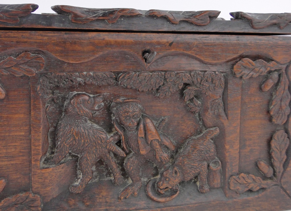 A 19th century rectangular oak box, relief carved with anthropomorphic studies of monkeys and dogs, - Image 3 of 3