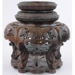 A large 19th century Chinese carved and pierced hardwood rotating stand for a porcelain vase,