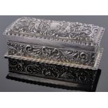 An Edwardian silver ring box, embossed allover with cherubs and scrolls,