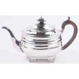 A George III silver teapot, on cast paw feet, London 1809, 16.15 oz.