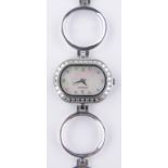 A lady's modern stainless steel cased quartz wristwatch, mother of pearl dial and diamond bezel,