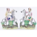 Pair of 19th century Staffordshire pottery figures riding zebras, height 19cm.