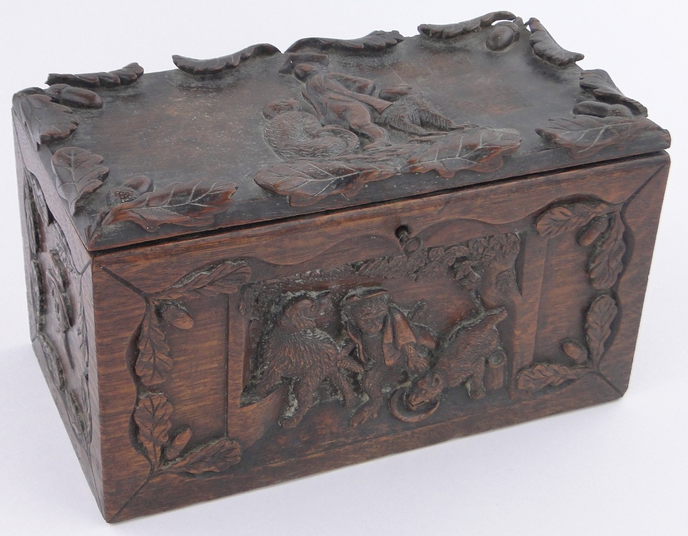 A 19th century rectangular oak box, relief carved with anthropomorphic studies of monkeys and dogs,