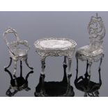 2, 19th century Dutch silver doll's house chairs and an oval table, Dutch hallmarks, table length 4.