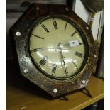 An octagonal carved cased wall clock with weights.