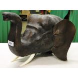 A leather covered elephant's head wall ornament.