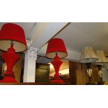 A pair of red velvet covered table lamps and shades and a pair of glass and metal table lamps and