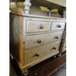 A Victorian pine chest with raised shaped back, 4 drawers under on bun feet.