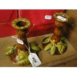 A pair of Rye Pottery hop decorated candlesticks.