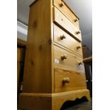 A narrow pine 5-drawer chest.