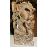 A large ornate Eastern hardwood carving of dragons.