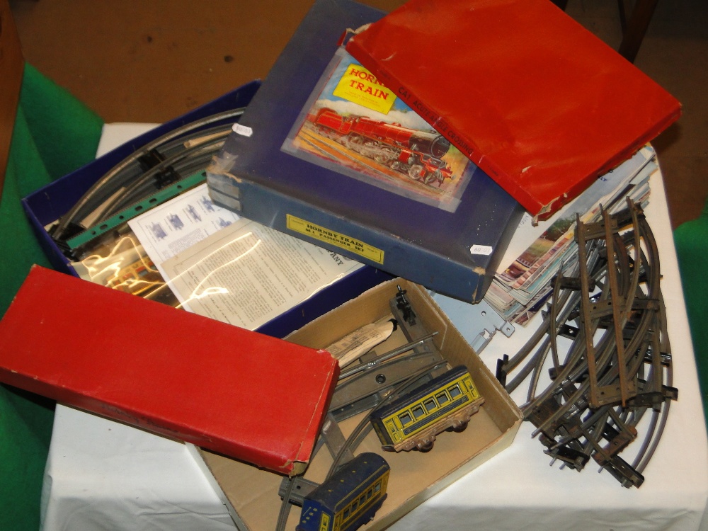 A Hornby train set and boxes containing carriages and tracks,