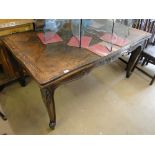 A French oak parquetry topped draw leaf dining table on cabriole legs.