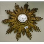 Vintage carved wood sunburst wall clock.