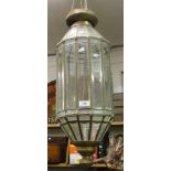A Moroccan style brass framed lantern with bevelled glass panels.