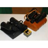 A pair of Minolta cased binoculars, Skybolt binoculars and a brooch.