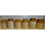 A shelf of Stoneware storage jars.