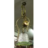 A rise and fall brass lamp with floral decorated shade.