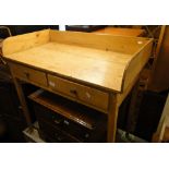 A continental pine wash stand with raised back, 2 drawers and square tapered legs.