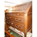 A French carved and panelled oak 2-drawer bureau.