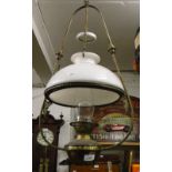 A brass framed hanging oil lamp complete with shade, smut collector and chimney.