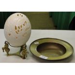 A carved and pierced ostrich egg with design of elephants on brass stand and a brass dish.