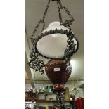 A ceramic hanging lantern with wrought-metal chains.