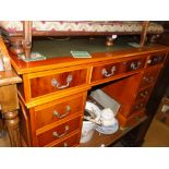 A reproduction yewwood twin pedestal writing desk.