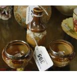 A miniature Doulton Stoneware bottle and a pair of Doulton salts and 2 silver rimmed salt pots.