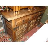 A Spanish hardwood design sideboard with drawer and cupboards.