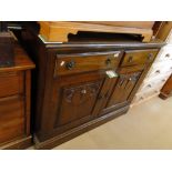 An Art Nouveau walnut sideboard with drawer and cupboards.