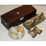 An oak candle box containing cutlery, opera glasses and eggs.