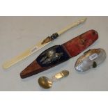 A mother of pearl purse, an ivory paper knife, cased manicure items and a caddy spoon.