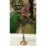 A weather vane surmounted by a copper duck.