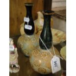A pair of Doulton Lambeth bottle vases.