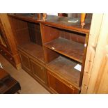 A mahogany 2-section cabinet with open shelves and cupboards under.